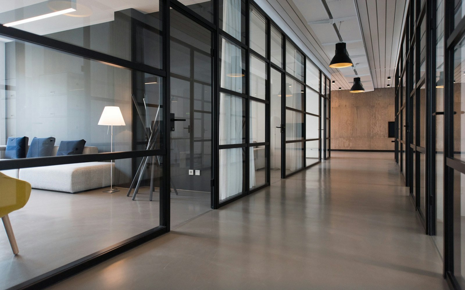 Clean, modern commercial building corridor with glass partitions